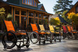 Many wheelchairs outside in a row in front of hotel sanatorium or nursing home to rest enjoy nature. Special needs for disabled people in any age. Healthcare senior retirement support care concept