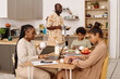 © AnnaStills - Family eating breakfast and getting ready for new day in school and office