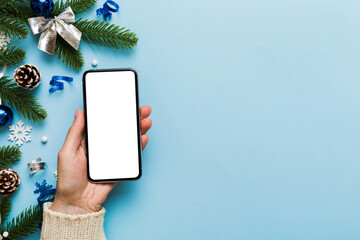 christmas mockup with space for text. christmas advertising, app template. hand holding phone with e