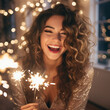 © Valentin - blissful curly woman with sparklers enjoying christmas time. indoor photo of laughing pretty girl with ben