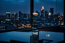 A Minimalist Single Flower Vase On A Modern Glass Table In A Sleek, High-rise Apartment With Floor-to-ceiling Windows, Overlooking A Bustling Cityscape At Night