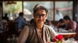 Indian Woman Female Sitting in Restaurant at Lunch Looking at Camera, Smiling with Glasses, Middle Aged Business Woman