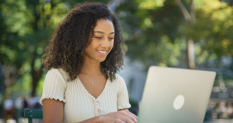 Poster - Young black woman working on laptop computer at a park