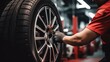 © ETAJOE - Male technician working at car tires service shop