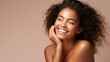 Beautiful smiling young woman with soft glow skin and bare shoulders.