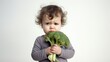 Sad kid dislike vegetables. Funny little boy doesn't want eat green broccoli. Cute child reject healthy food and hate vitamins. Unhappy childhood concept. Upset children kindergarten. White background
