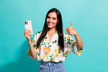 Poster - Photo of lovely pretty girl wear stylish clothes use modern device recommend novelty thumb up isolated on bright cyan color background