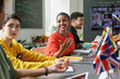 © Mediaphotos - Group of students discussing together while sitting at table at conference