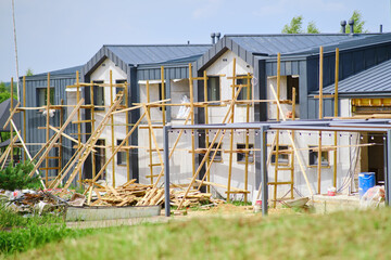 Two-storey wooden building in scaffolding for repair and reconstruction of walls