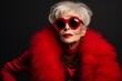 © Darya Lavinskaya - High fashion studio portrait of beautiful old woman wears sunglasses, red dress and red lipstick