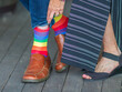 showing rainbow socks on man
