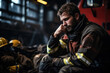 Exhausted firefighter in empty fire station background with space for text 