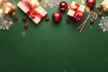 Wall Mural - Christmas or New Year background. Paper gift boxes, with red ribbon and tie bow, Christmas balls on green background with copy space top view