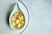 Baked Organic Garlic In Oil On Spoon
