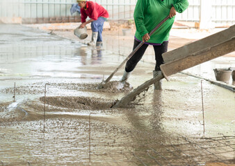 Truck load concrete to formwork and worker leveling floor.