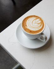 Cup Of Cappuccino Over Marble Table