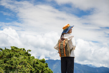 Wall Mural - Asian girl on mountain peak