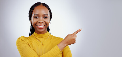 Poster - Portrait, smile and black woman with hand pointing in studio for presentation, checklist or promo on grey background. Timeline, schedule and face of female model show faq, menu or step, guide or info