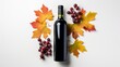 Bottle of wine with ripe grapes and orange leaves isolated on a white background Bottle of red wine with label Wine bottle mockup. top view, flat lay with copy space