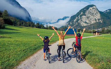 Happy family with arms raised up in bike