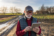 © Budimir Jevtic - Senior farmer with tablet on ranch