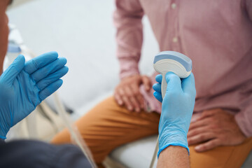 Diagnostician works on an ultrasound machine in a medical facility