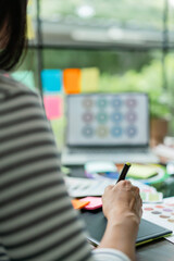 Poster - creative graphic designer choose color swatch on laptop and working to designing project on tablet