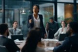 Fototapeta  - a black woman business leader dressed as an executive leading an important meeting as everyone looks on