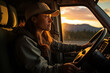 A strong and determined truck driver drives her cargo truck along a highway at sunset with a mountainous landscape in the background and a golden sun illuminating her face