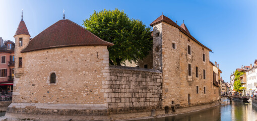 Wall Mural - Quai de l'ile on the Thiou river, at setting sun, and the Palais de l'Isle, in Annecy, Haute-Savoie, France