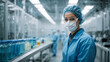 Biotechnology production facility, pharma. Clean production room with worker in blue protective clothes.