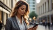 © New generate - Close-up image of business woman watching smart mobile phone device outdoors. Businesswoman networking typing an sms message in city street. full body