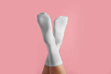 Wall Mural - Woman in stylish white socks on pink background, closeup