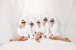 © wedmoments.stock - Well-groomed girls get together to celebrate a bachelorette party. Women after spa treatments, wrapping their heads in a towel, enjoy the fun. Concept of entertainment and spa treatments for women.