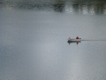 Lone Boat Motoring Across A Body Of Water