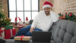 © Krakenimages.com - African american man having video call celebrating christmas at home