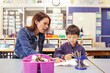 © Austockphoto - Happy primary school student working with teacher