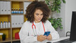 © Krakenimages.com - Young beautiful hispanic woman doctor using smartphone at clinic