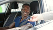 © Krakenimages.com - African american man smiling confident receiving key of new car at street