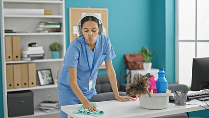 Poster - African american woman professional cleaner cleaning table listening to music at the office