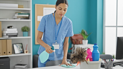 Poster - African american woman professional cleaner cleaning table at the office