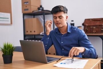 Sticker - Young hispanic man business worker stressed using laptop at office