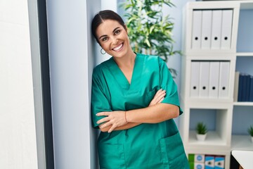 Sticker - Young beautiful hispanic woman nurse smiling confident standing with arms crossed gesture at clinic