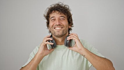 Sticker - Young hispanic man smiling confident wearing headphones over isolated white background