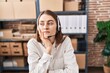 Young caucasian woman working at small business ecommerce wearing headset thinking looking tired and bored with depression problems with crossed arms.
