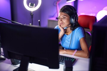 Sticker - Brunette young woman playing video games thinking looking tired and bored with depression problems with crossed arms.