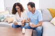 © Krakenimages.com - Man and woman couple holding pills reading prescription at home