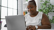 © Krakenimages.com - Focused african american woman worker excelling in business. working diligently at her laptop, this boss lady embodies success and professionalism in her office.