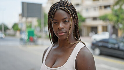 Wall Mural - African american woman standing with serious expression at street