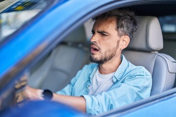 Poster - Young hispanic man stressed driving car at street